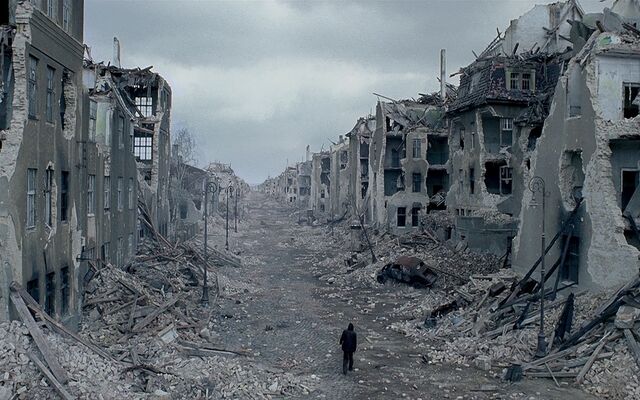 640px-Man-walking-through-destroyed-city.jpg
