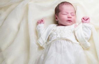 newborn baby in christening gown